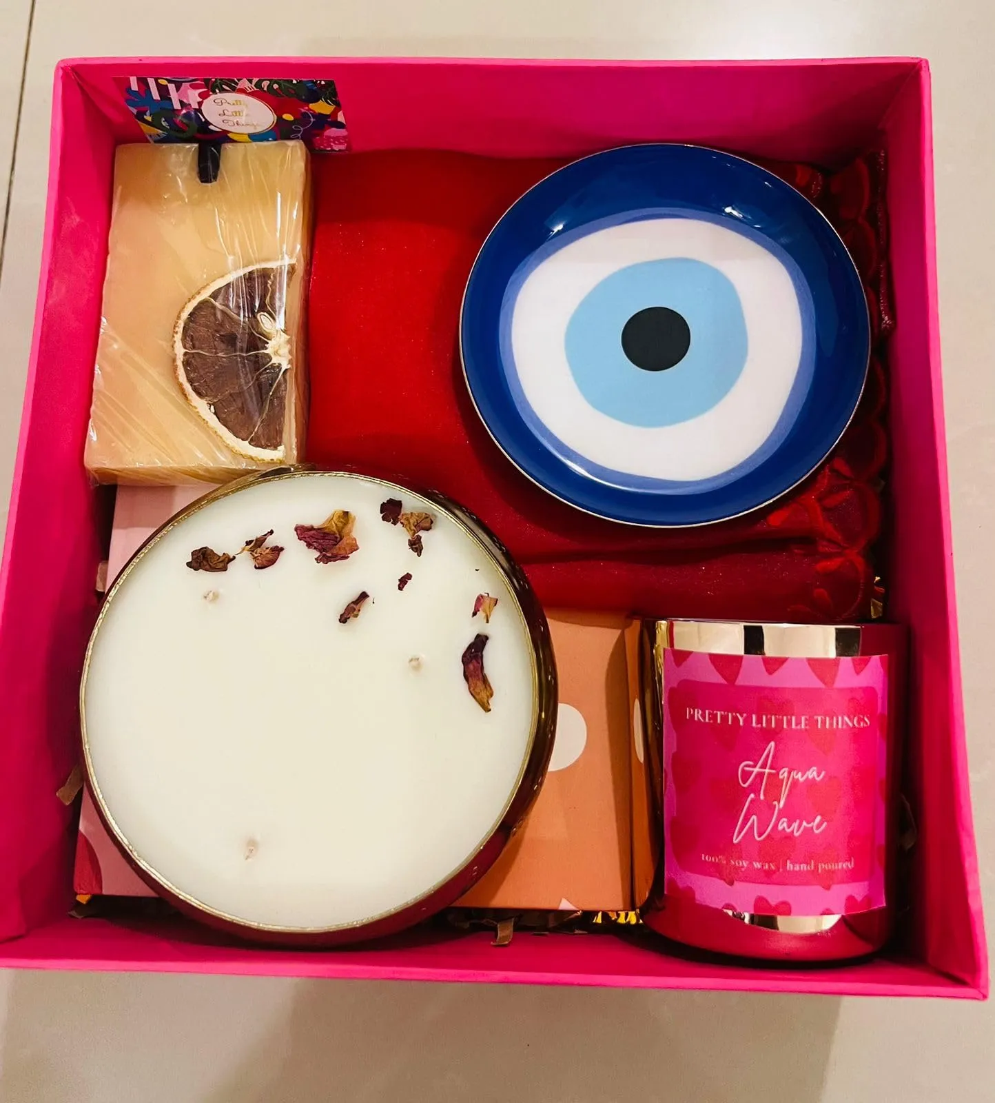 Luxury candle Pink Gift Surprise Hamper.Has 1 Lady Love Metallic Glass Pillar Candle,1 Hardbound Notebook,1 Evil Eye Coaster,1 Scented Wax tablet,1 Pooja Cloth.1 Mini Urli Candle. Birthday,Diwali