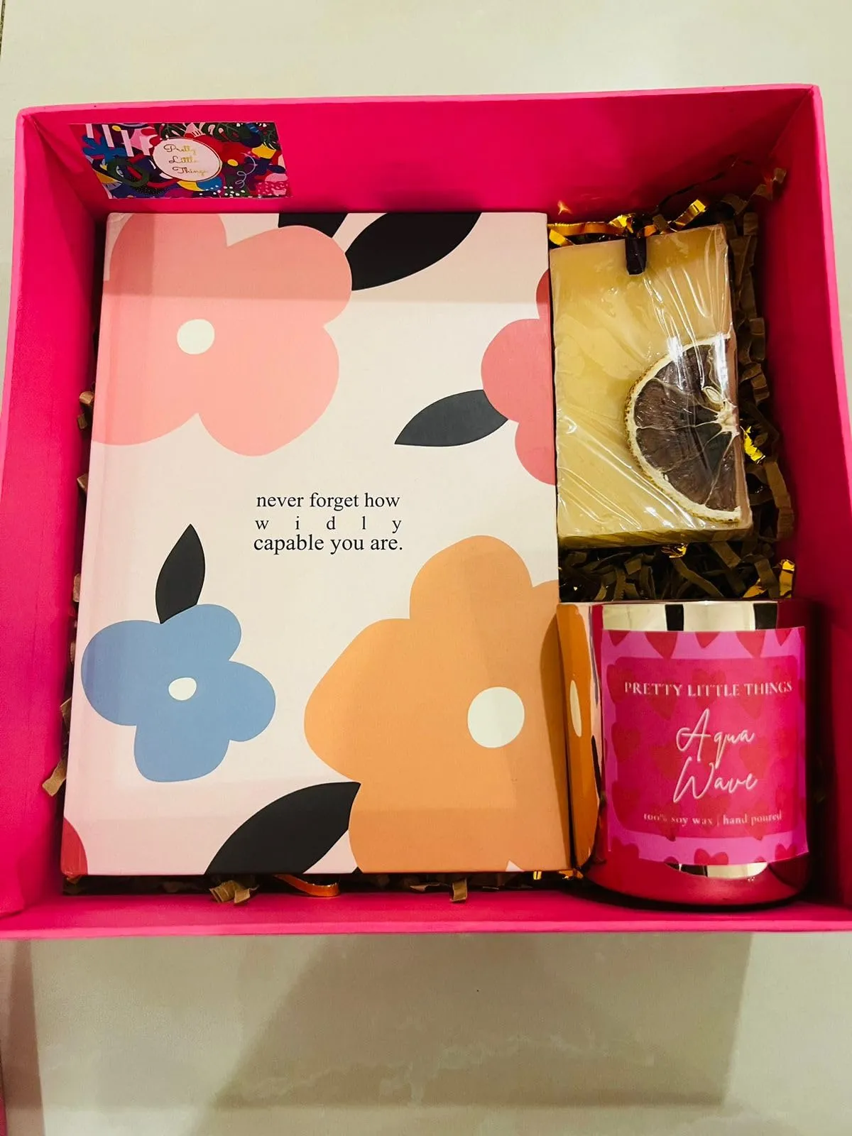 Luxury candle Pink Gift Surprise Hamper.Has 1 Lady Love Metallic Glass Pillar Candle,1 Hardbound Notebook,1 Evil Eye Coaster,1 Scented Wax tablet,1 Pooja Cloth.1 Mini Urli Candle. Birthday,Diwali